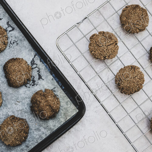 High angle close up of freshly baked chocolate cookies on a baking tray. High angle close up of freshly baked chocolate cookies on a baking tray.