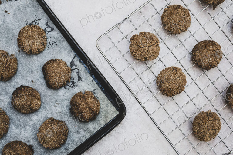 High angle close up of freshly baked chocolate cookies on a baking tray.