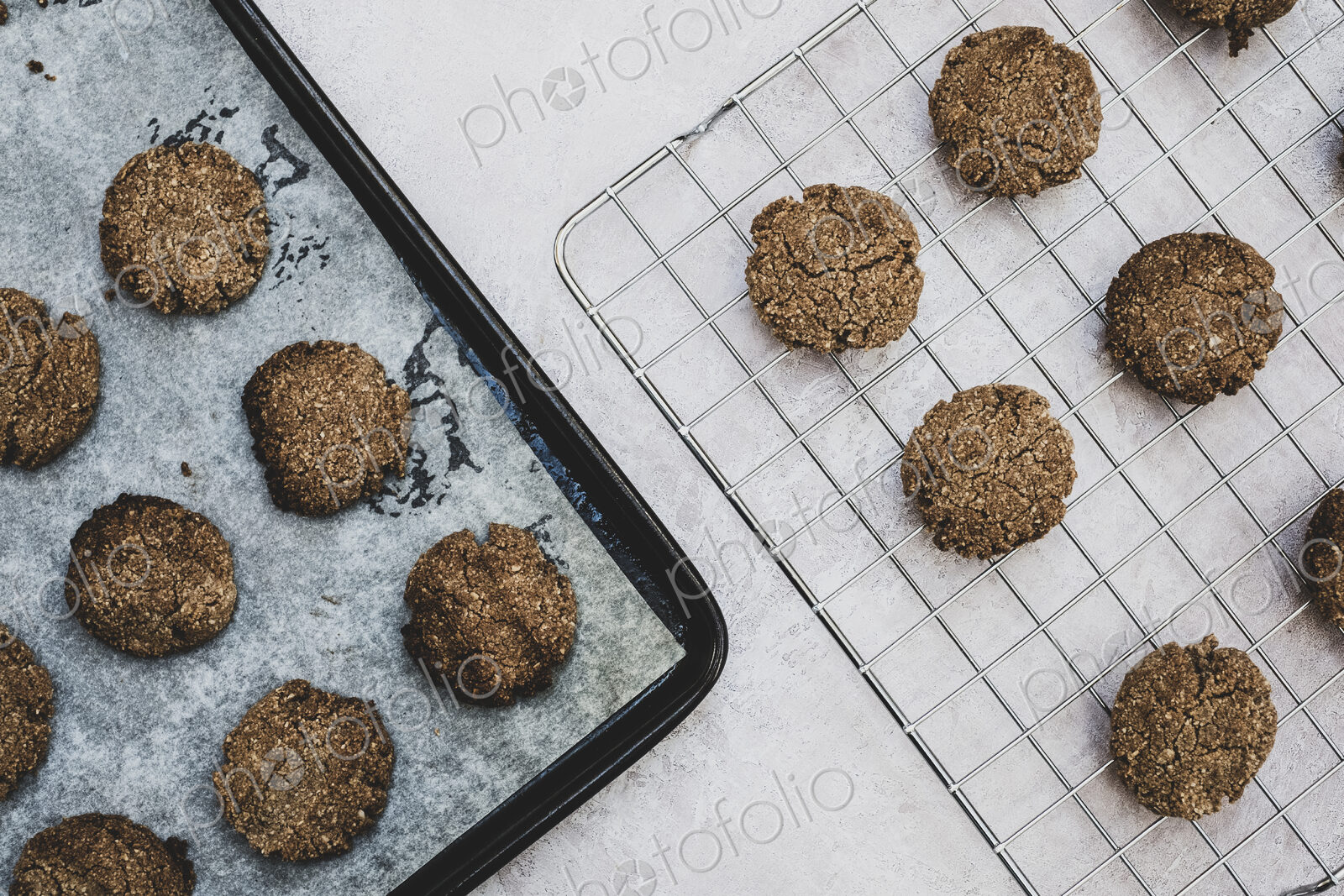 High angle close up of freshly baked chocolate cookies on a baking tray.