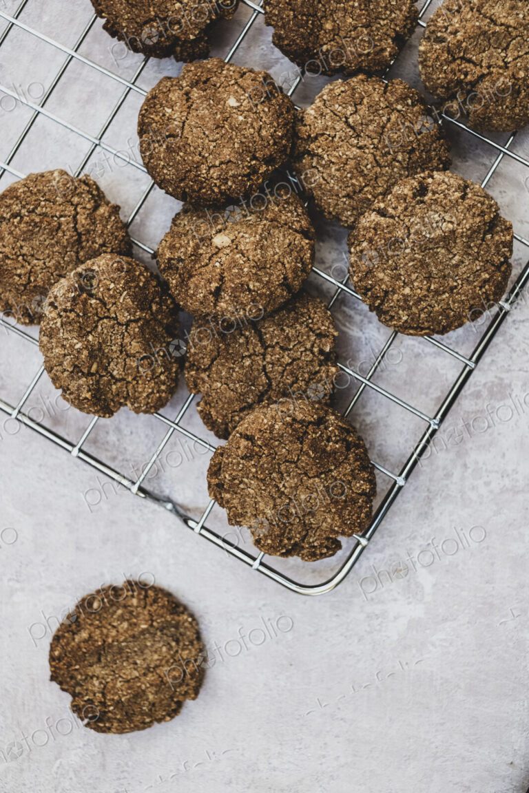 High angle close up of freshly baked chocolate cookies on a baking tray.
