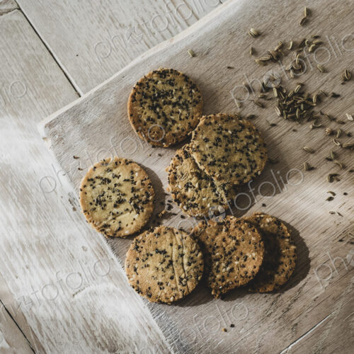 High angle close up of freshly baked seeded crackers.