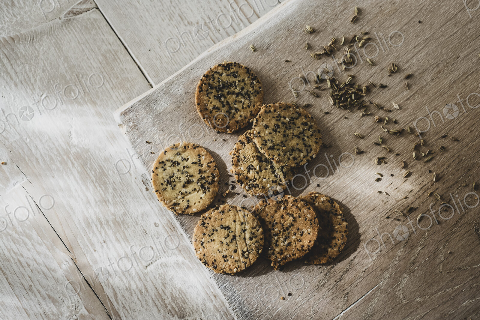 High angle close up of freshly baked seeded crackers.