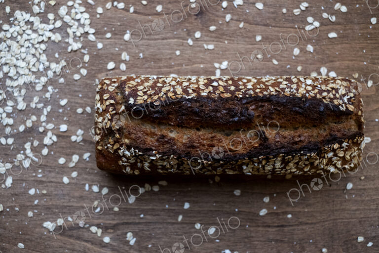 High angle close up of freshly baked seeded loaf of bread in an artisan bakery.