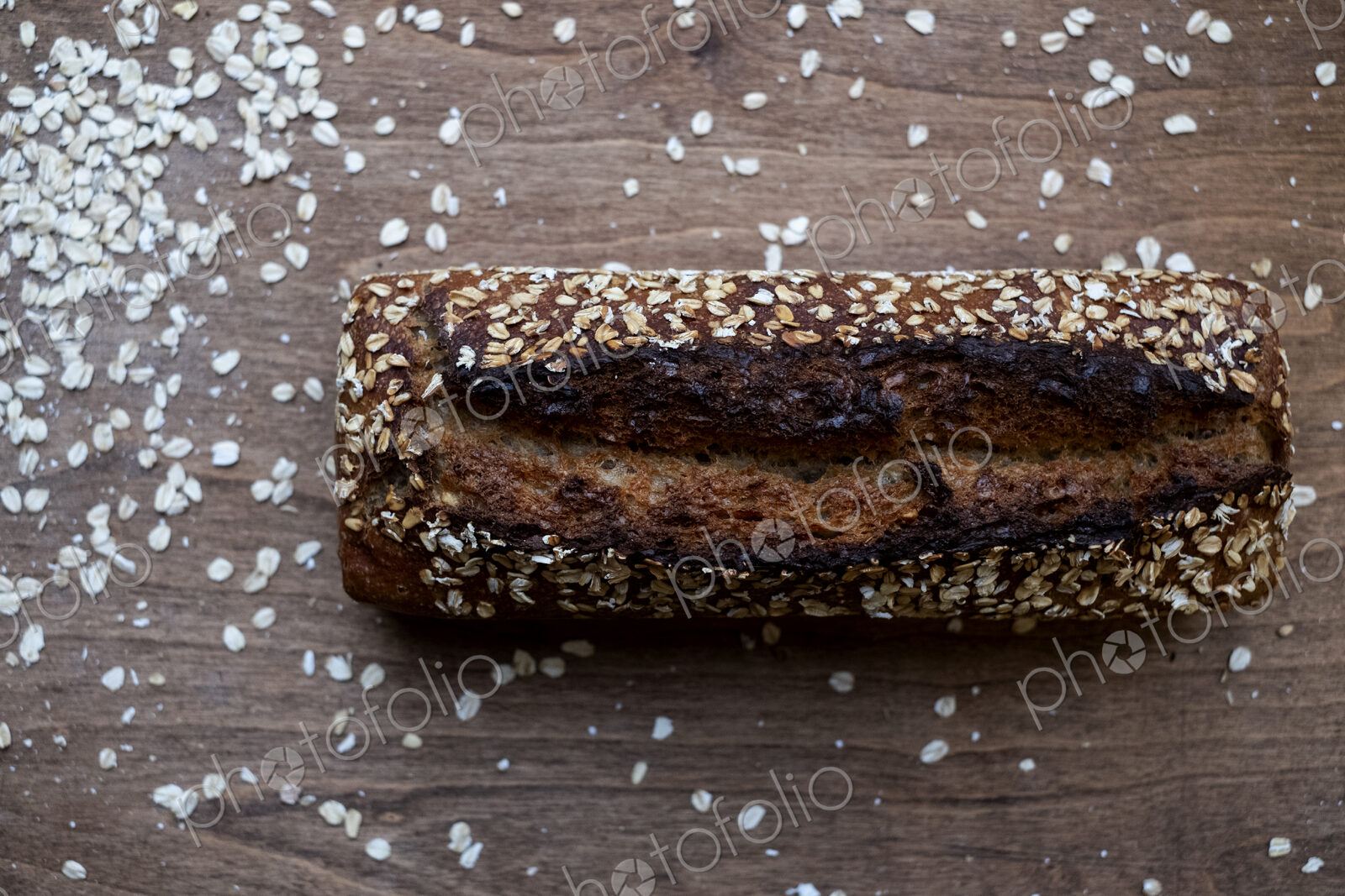 High angle close up of freshly baked seeded loaf of bread in an artisan bakery.