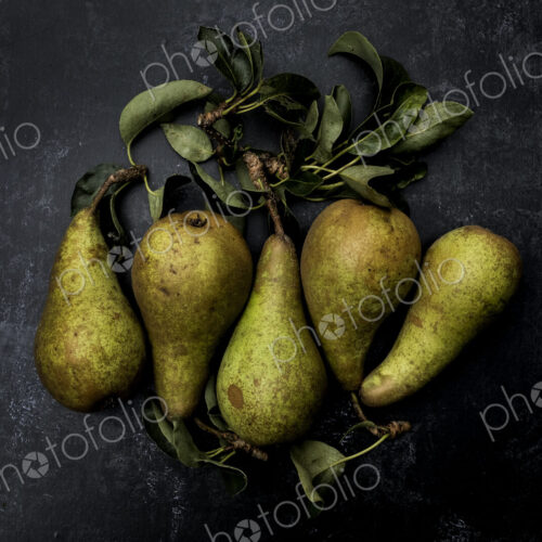 High angle close up of green pears on black background. High angle close up of green pears on black background.