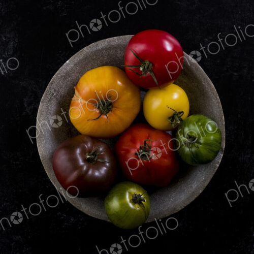 High angle close up of grey plate with selection of tomatoes in various shapes and… High angle close up of grey plate with selection of tomatoes in various shapes and…