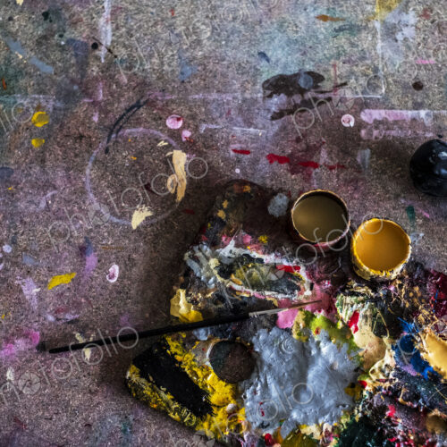 High angle close up of painter's palette and paintbrush in a workshop. High angle close up of painter's palette and paintbrush in a workshop.