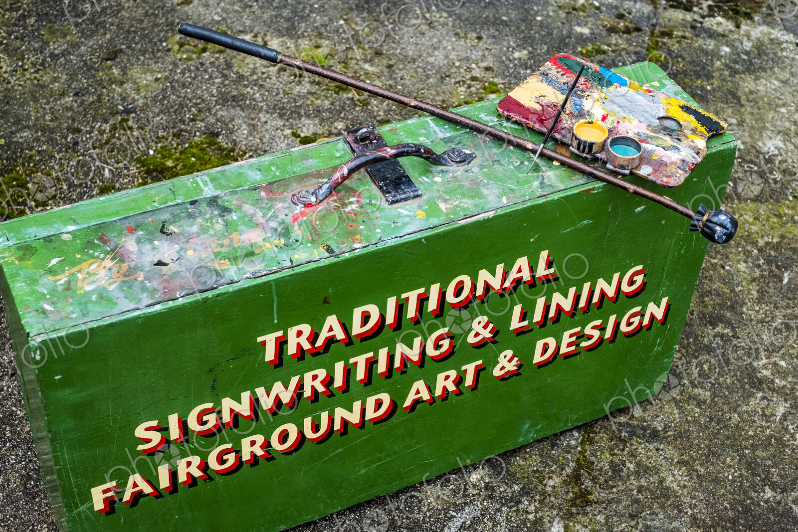 High angle close up of painting materials on green metal toolbox of traditional…