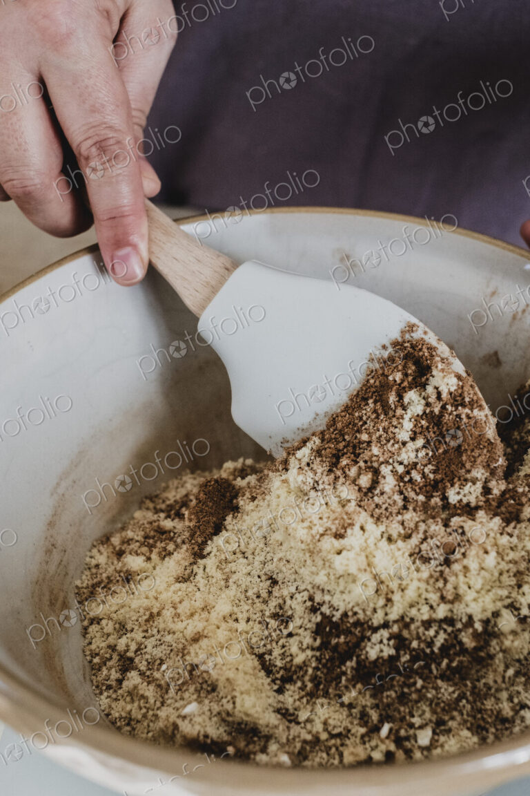 High angle close up of person mixing baking ingredients using spatula.