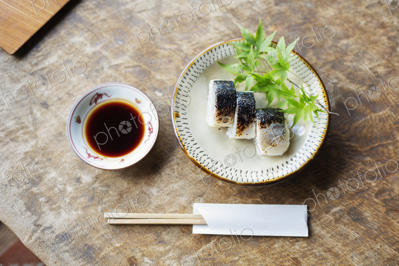 High angle close up of plate of Sushi and bowl of Soy Sauce on a table in Japanese…