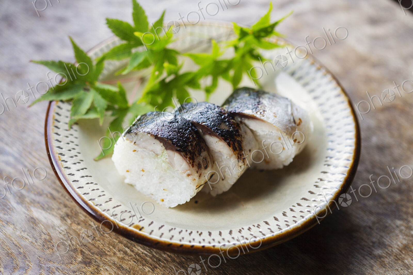 High angle close up of plate of Sushi and bowl of Soy Sauce on a table in Japanese…