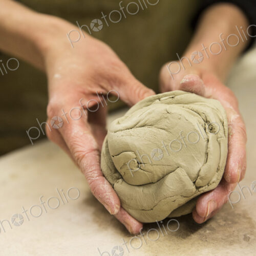 High angle close up of potter kneading piece of pottery clay. High angle close up of potter kneading piece of pottery clay.
