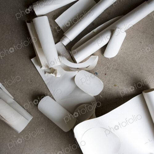 High angle close up of rolls and cut-offs of stiff rolled drawing paper. High angle close up of rolls and cut-offs of stiff rolled drawing paper.