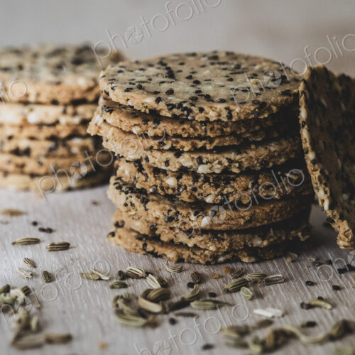 High angle close up of stack of freshly baked seeded crackers. High angle close up of stack of freshly baked seeded crackers.