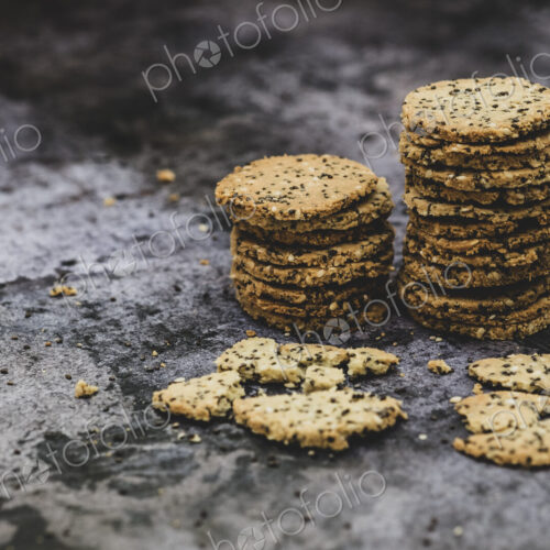 High angle close up of stack of freshly baked seeded crackers. High angle close up of stack of freshly baked seeded crackers.