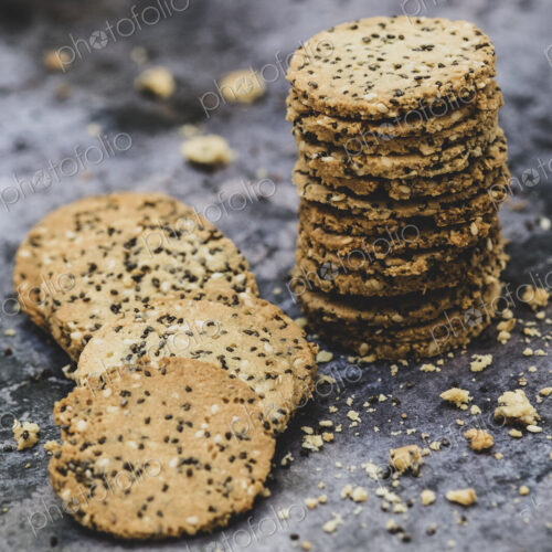 High angle close up of stack of freshly baked seeded crackers. High angle close up of stack of freshly baked seeded crackers.