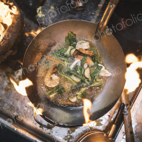 High angle close up of stir fry with prawns and green vegetables in stainless steel… High angle close up of stir fry with prawns and green vegetables in stainless steel…