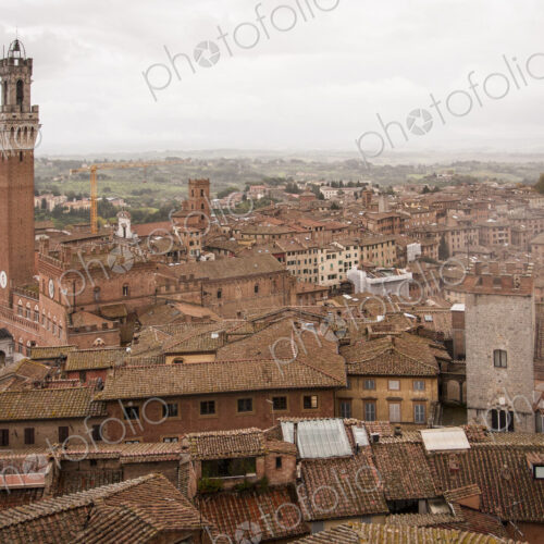 High angle view across the city of Siena with the Piazza del Campo and Torre del… High angle view across the city of Siena with the Piazza del Campo and Torre del…