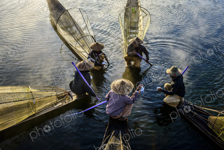High angle view of Asian fishermen fishing in canoes on river