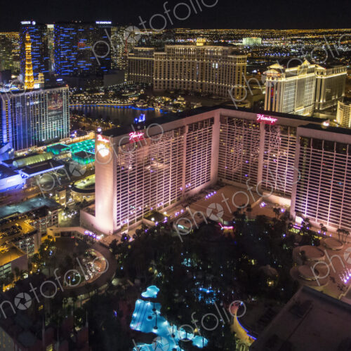 High angle view of Las Vegas at night, with the illuminated Flamingo hotel and casino… High angle view of Las Vegas at night, with the illuminated Flamingo hotel and casino…