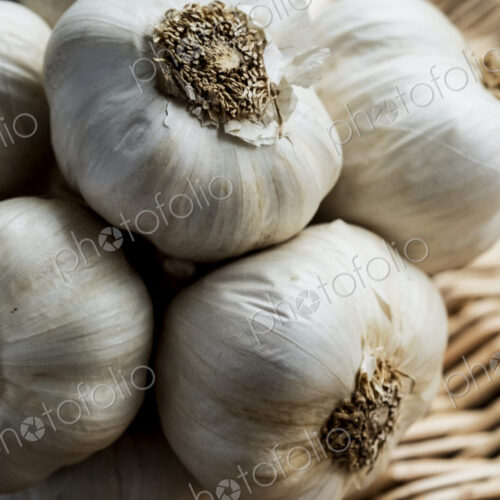 High angle view of a few garlic bulbs in a basket. High angle view of a few garlic bulbs in a basket.