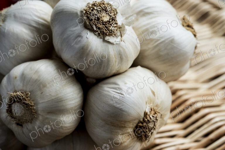 High angle view of a few garlic bulbs in a basket.