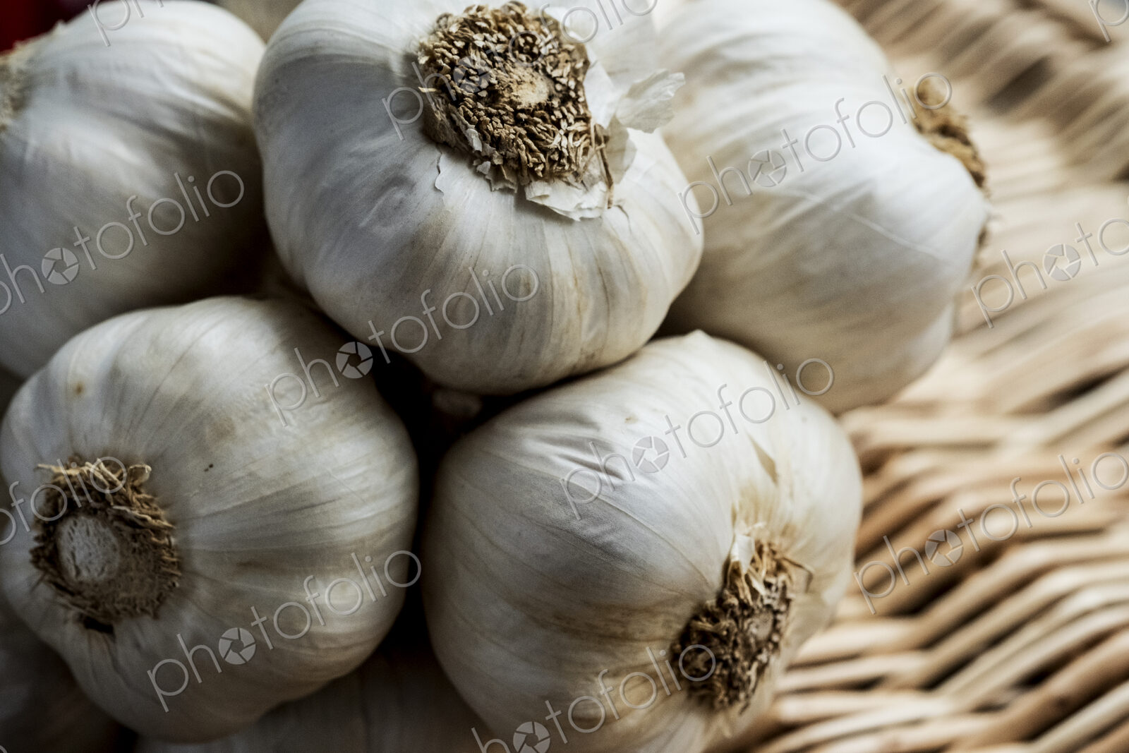 High angle view of a few garlic bulbs in a basket.