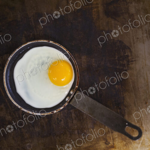 High angle view of a fried egg in a frying pan. High angle view of a fried egg in a frying pan.