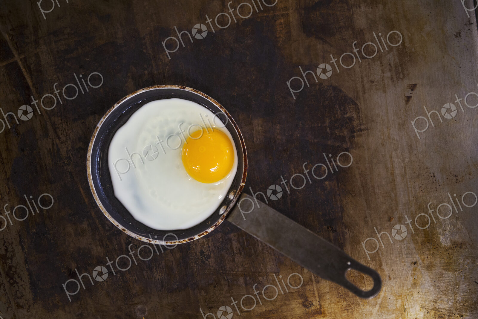 High angle view of a fried egg in a frying pan.