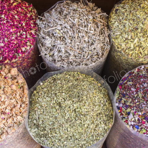 High angle view of a selection of colourful spices in bags. High angle view of a selection of colourful spices in bags.