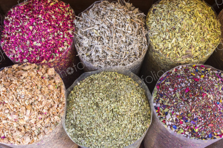 High angle view of a selection of colourful spices in bags.