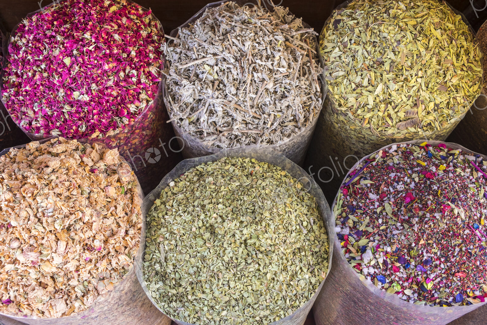 High angle view of a selection of colourful spices in bags.