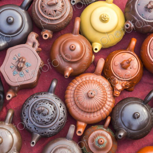 High angle view of a selection of oriental tea pots at a market stall. High angle view of a selection of oriental tea pots at a market stall.