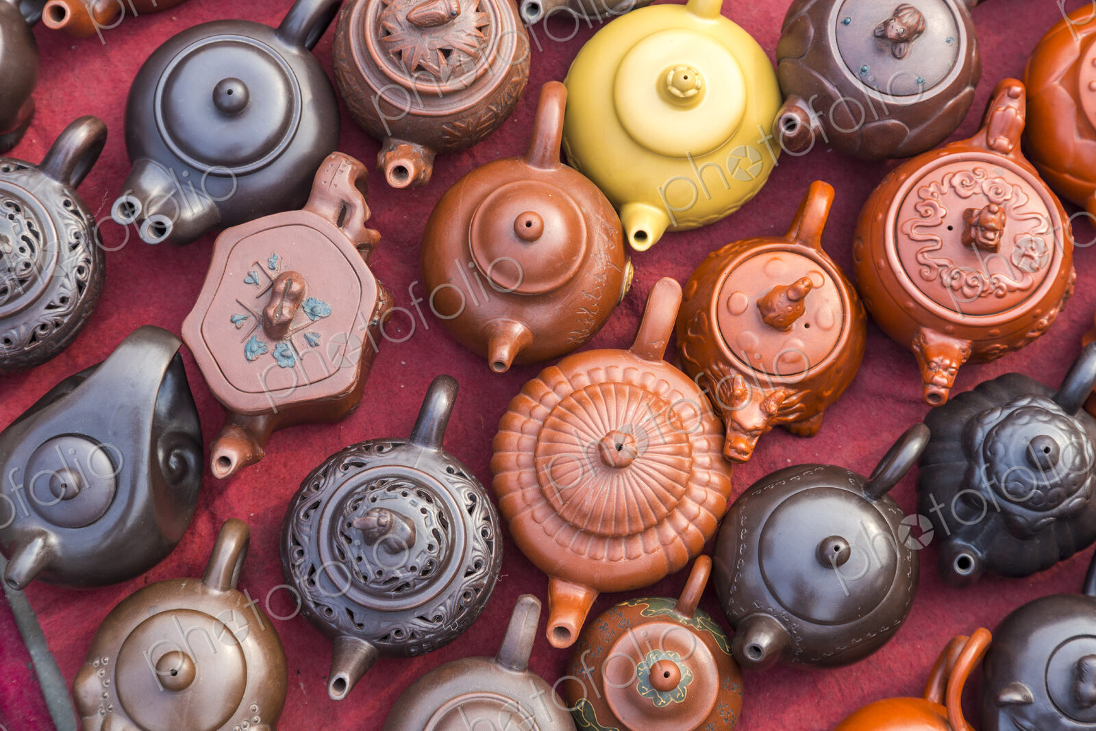 High angle view of a selection of oriental tea pots at a market stall.