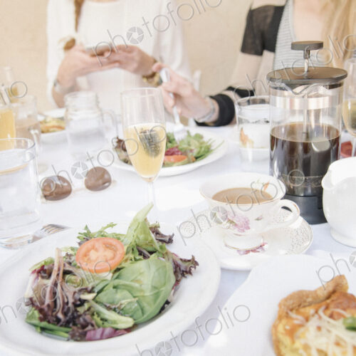 High angle view of a table with food and drink, plates with omelette and salad, coffee…