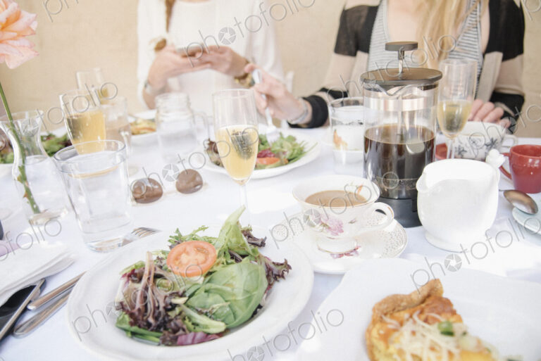 High angle view of a table with food and drink, plates with omelette and salad, coffee…