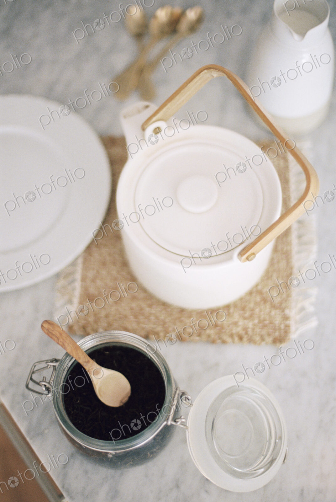 High angle view of a tea pot and a glass jar with tea leaves.