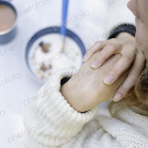 High angle view of a woman sitting at a table at breakfast.