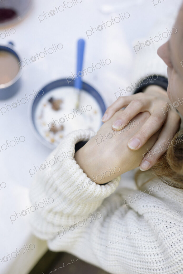 High angle view of a woman sitting at a table at breakfast.