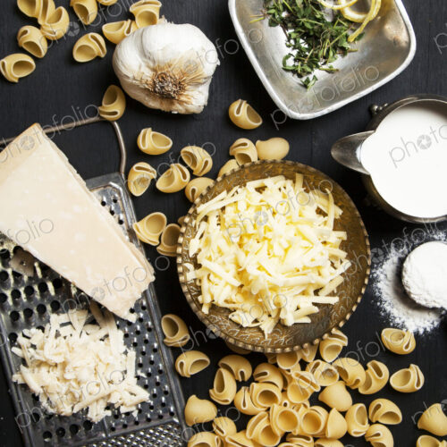 High angle view of cheese and pasta ingredients High angle view of cheese and pasta ingredients