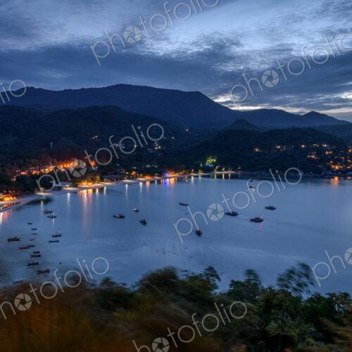 High angle view of fishing boats moored in a bay at sunset. High angle view of fishing boats moored in a bay at sunset.