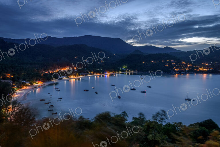 High angle view of fishing boats moored in a bay at sunset.