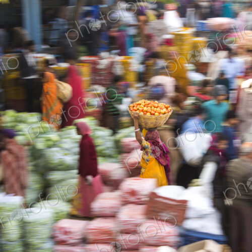 High angle view of fruit and vegetable market, woman carrying a load on her head,… High angle view of fruit and vegetable market, woman carrying a load on her head,…