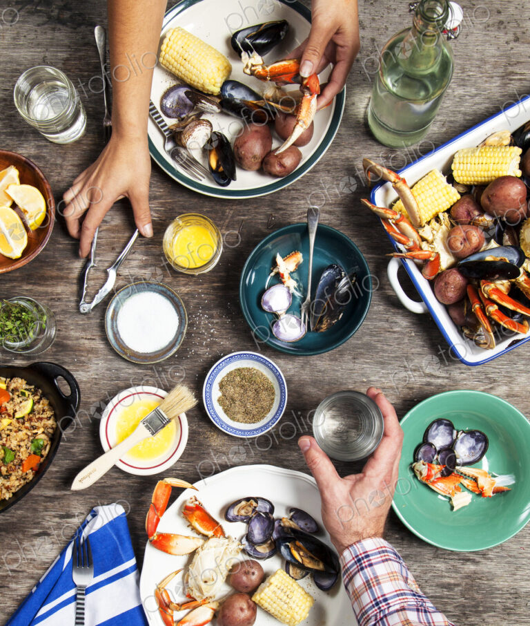 High angle view of hands at seafood dinner