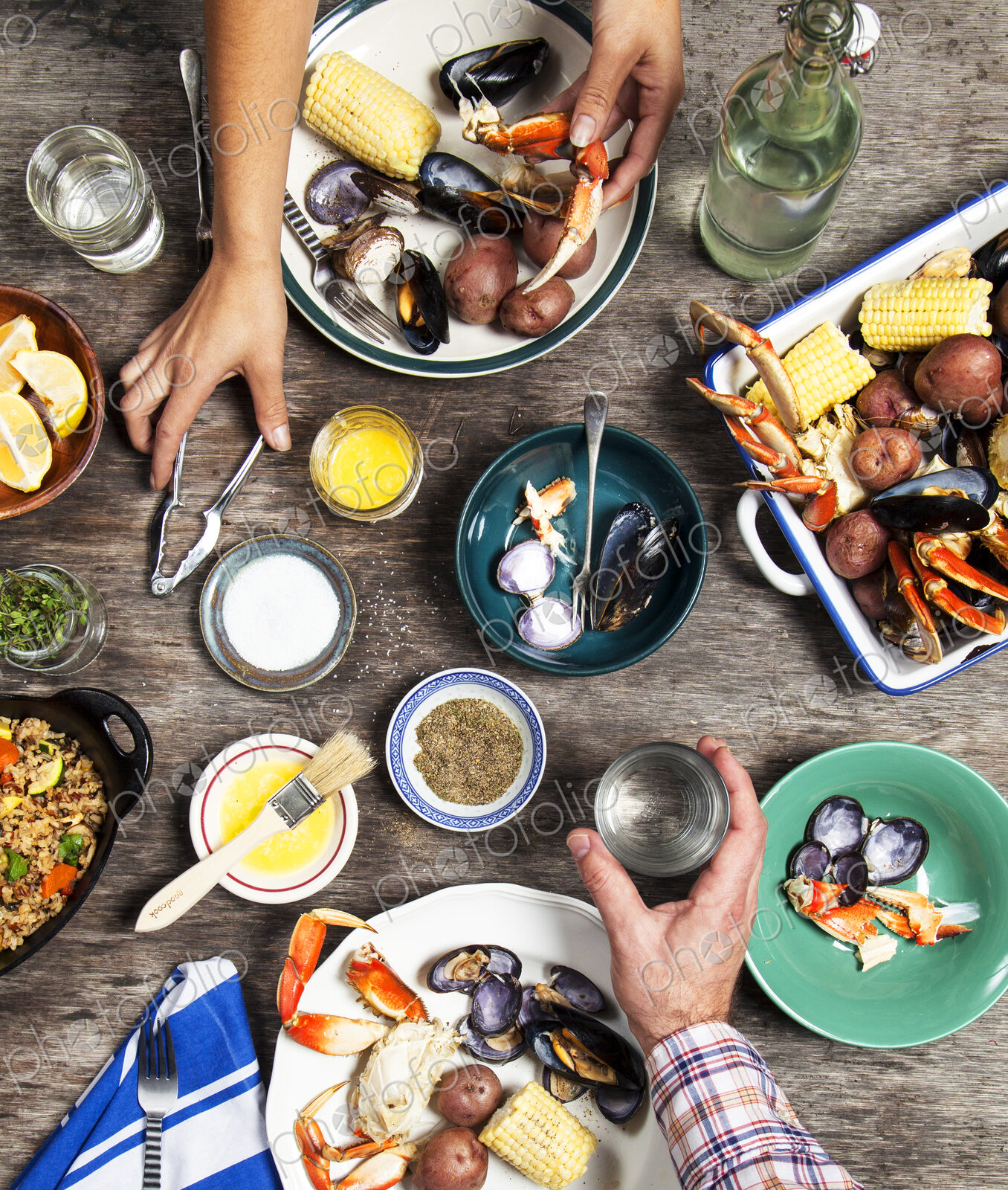High angle view of hands at seafood dinner