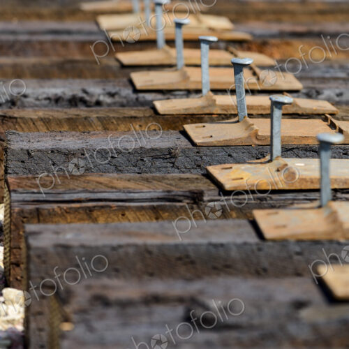 High angle view of railroad tracks and rail spikes High angle view of railroad tracks and rail spikes