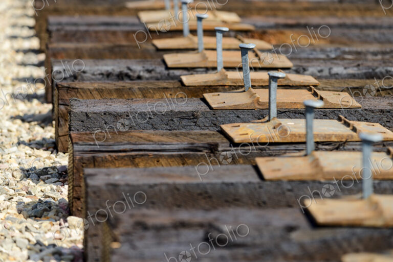 High angle view of railroad tracks and rail spikes