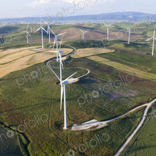High angle view of rolling landscape with fields and wind turbines. High angle view of rolling landscape with fields and wind turbines.