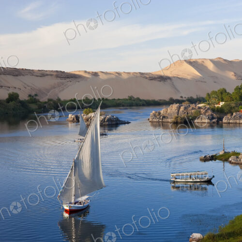 High angle view of sailboats on a river, sand hills in the distance. High angle view of sailboats on a river, sand hills in the distance.