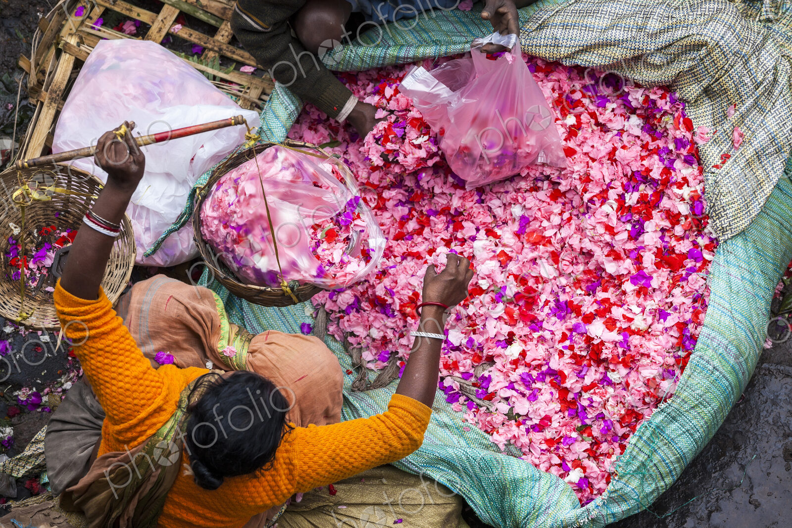 High angle view of vendor selling pink flower petals at a street market.